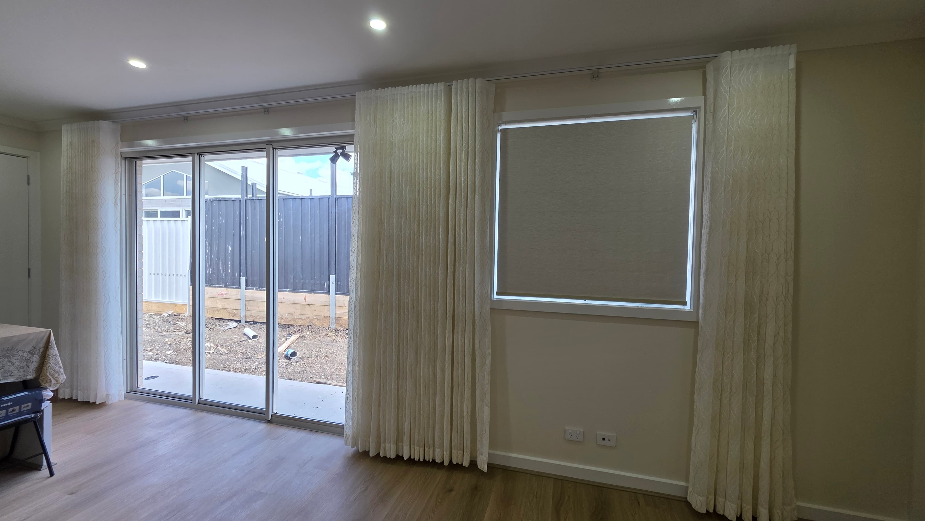 S-fold sheer curtains on sliding door with roller blind on side window