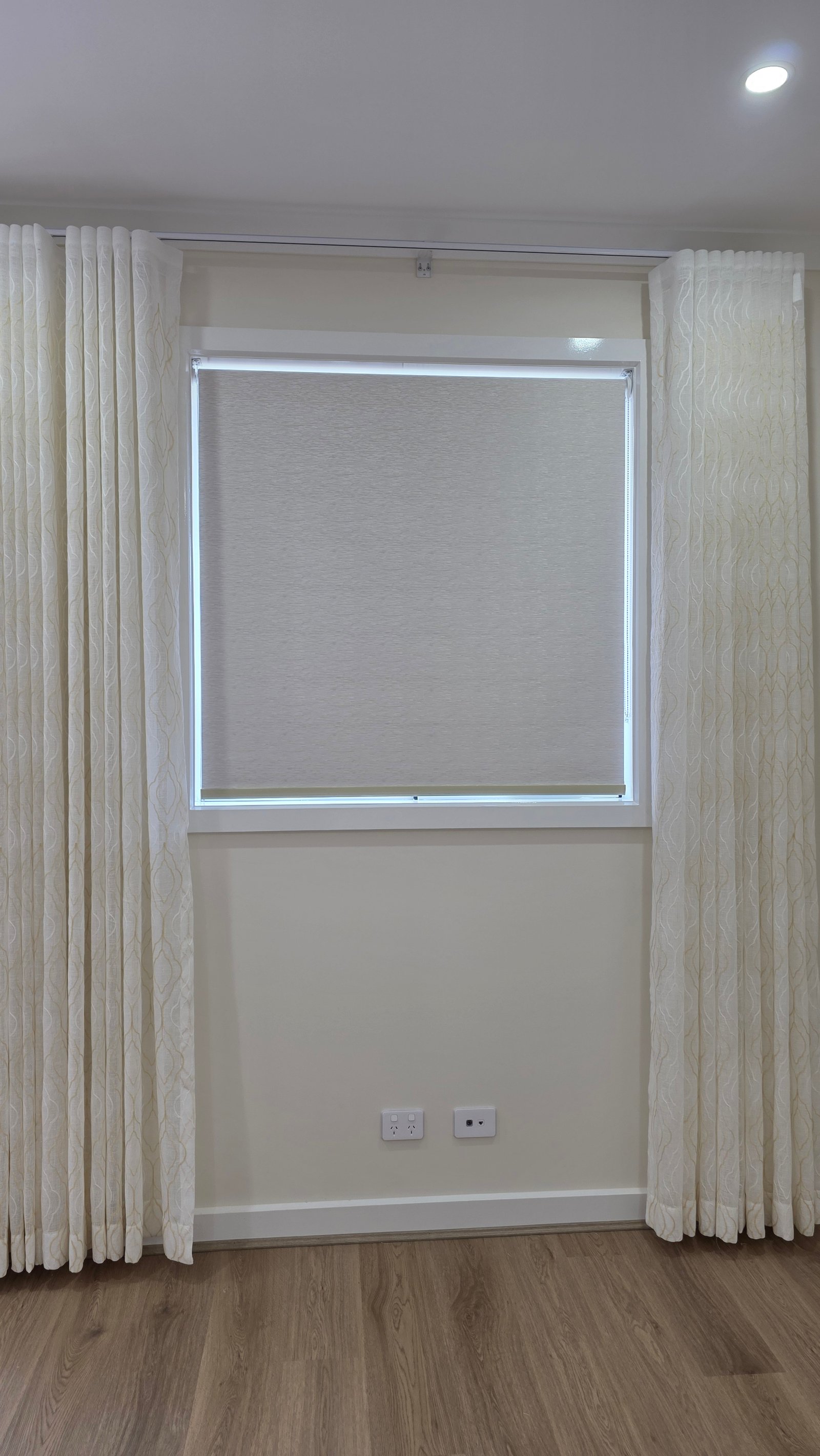 Fabric blinds on bedroom window with soft natural light filter