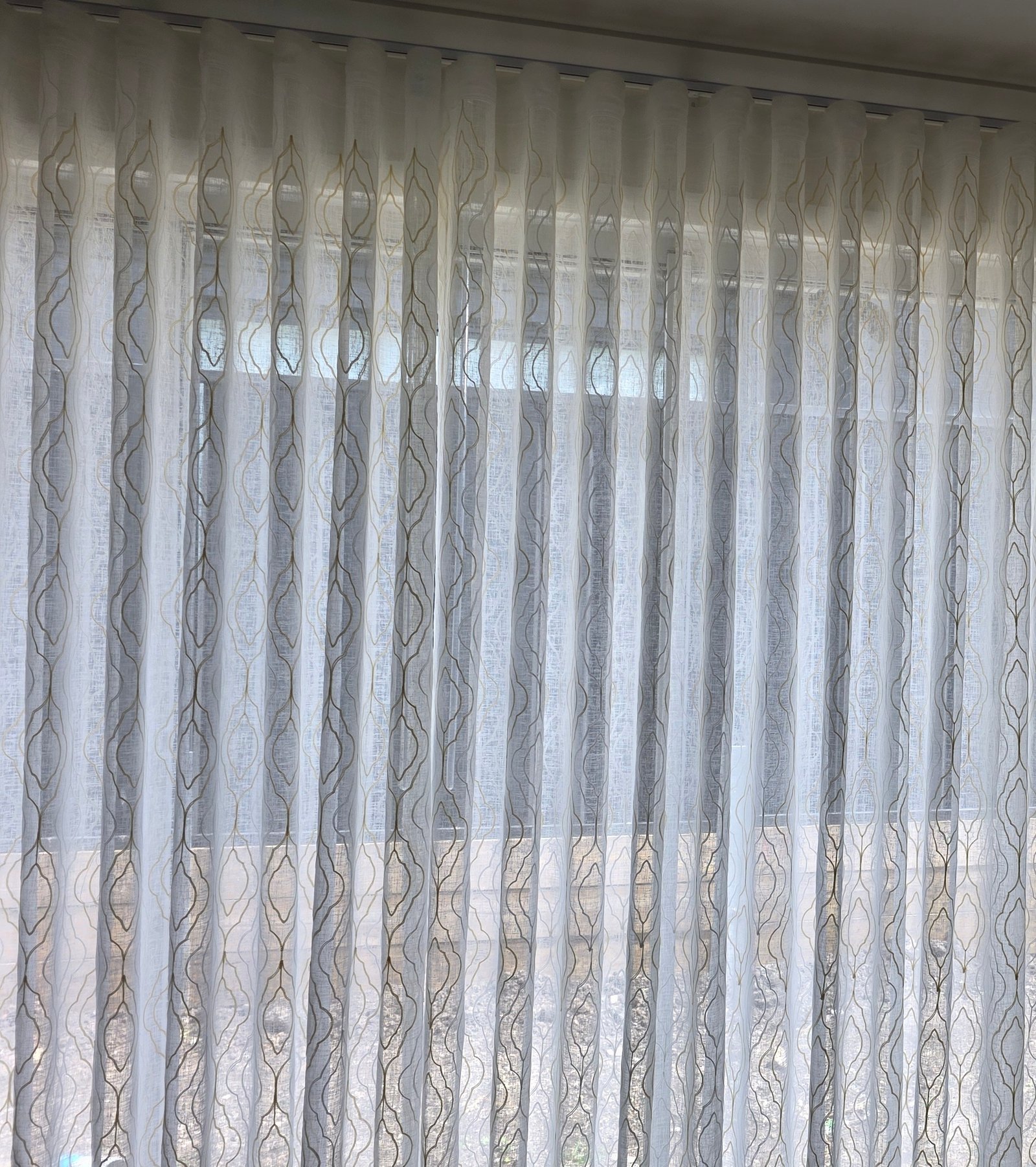 Sheer S-fold curtains with wave pattern, close detail shot